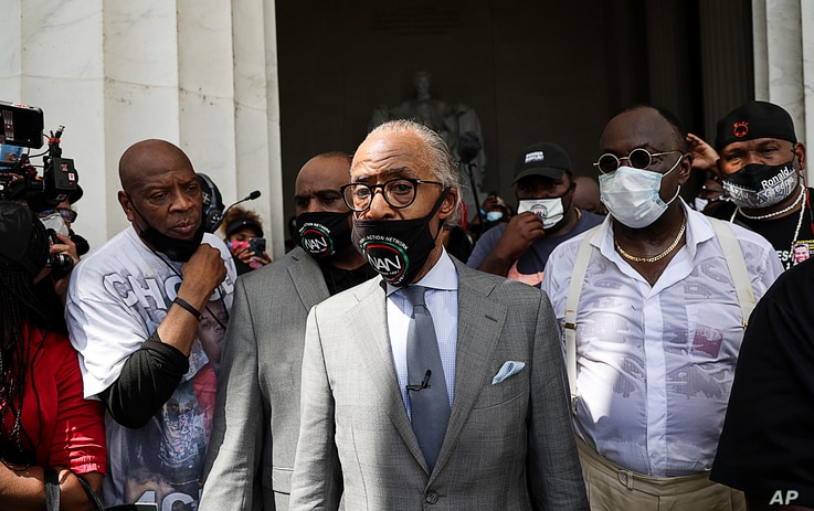 The Rev. Al Sharpton arrives to speak at the “Get Your Knee Off Our Necks March,
